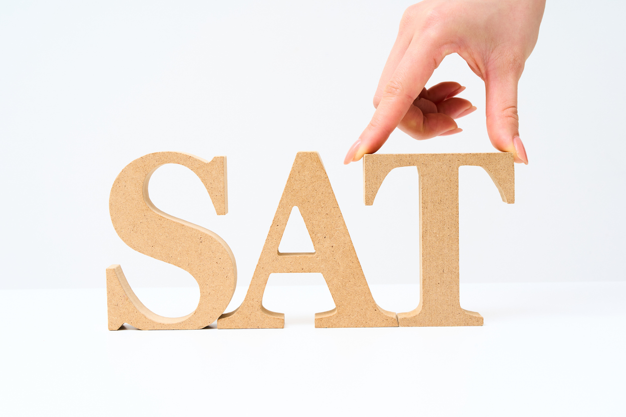 Wooden alphabet blocks arranged with the word “SAT”